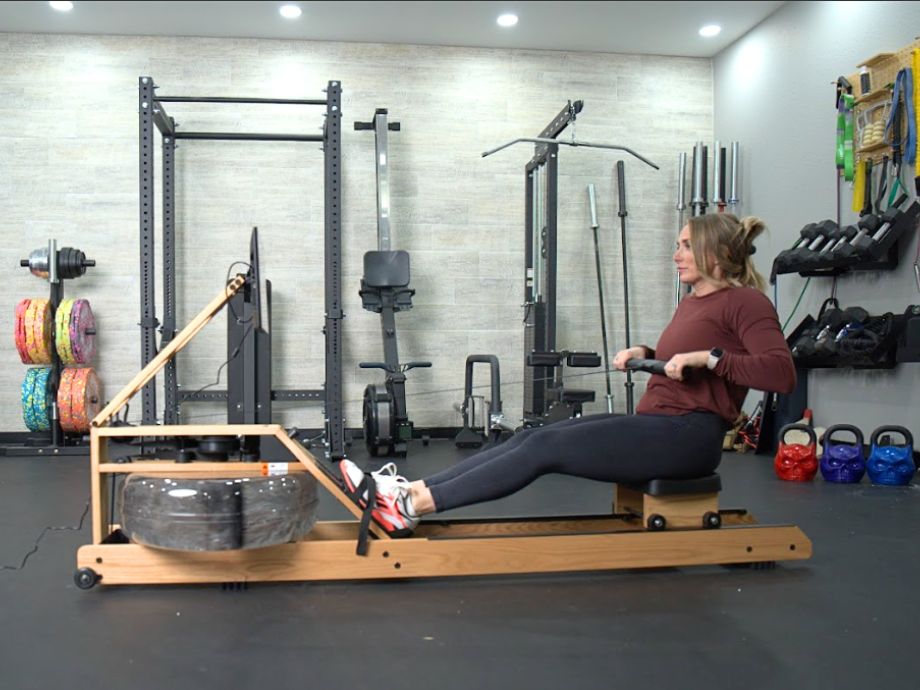 Woman rowing on the Ergatta Lite rowing machine