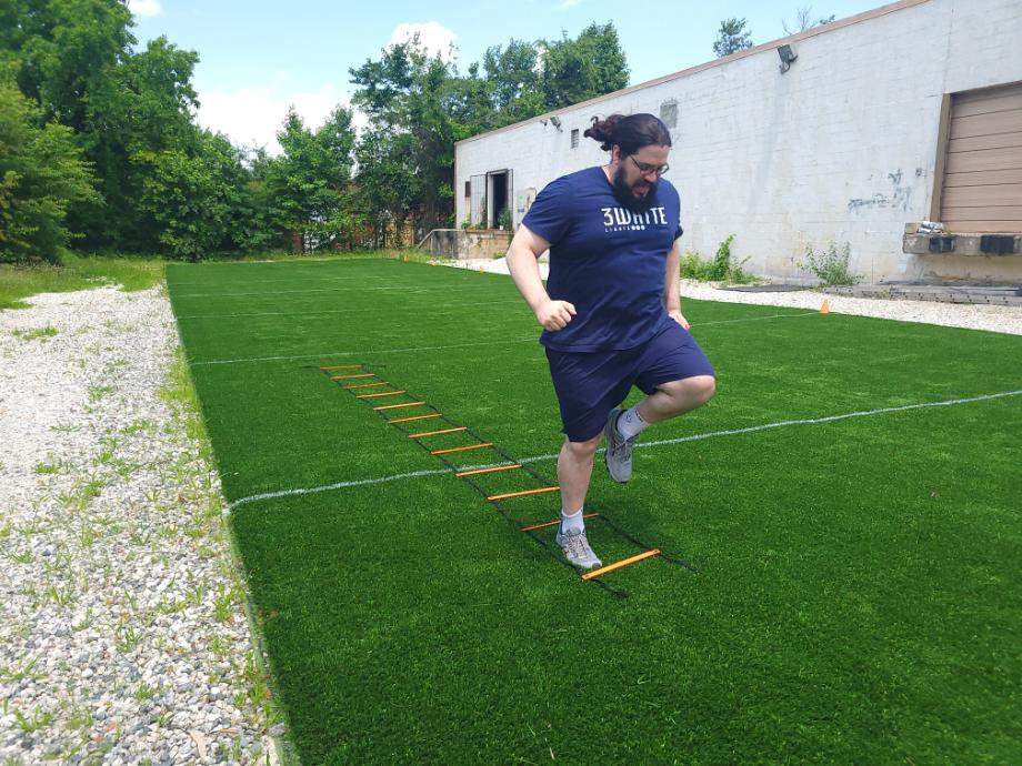 Olympian Caine Wilkes works on his footwork with the GHB Pro Agility Ladder.