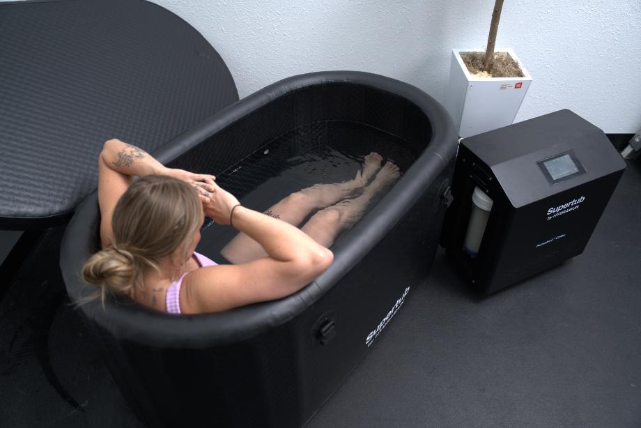 Looking down on Lindsay from behind as she sits in the Hydragun Supertub Cold Plunge.