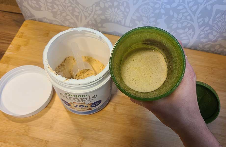 Looking down into a container of Orgain Simple Plant Protein
