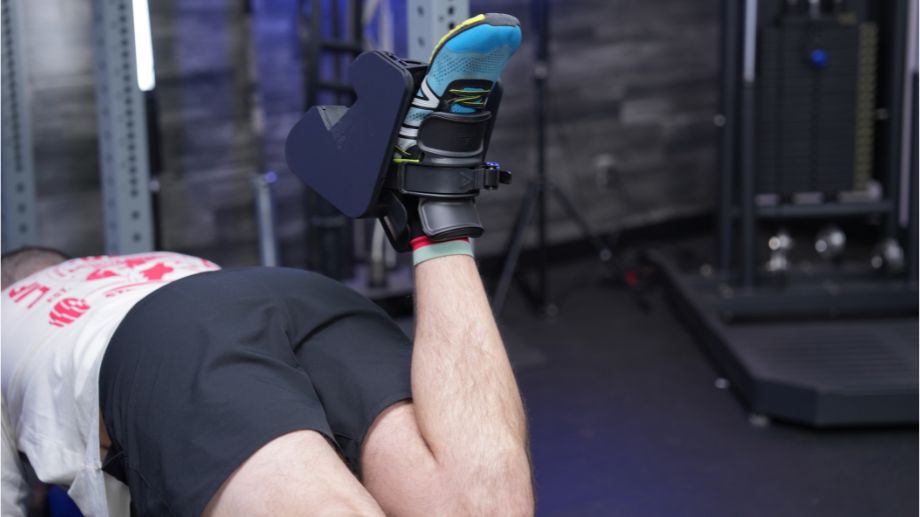 A man doing lying leg curls with the MonkeyFeet Pro.