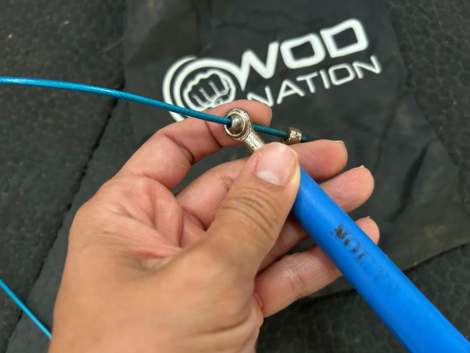 A close-up image of the blue WOD Nation Double Under Speed Rope's bearings on the handles.