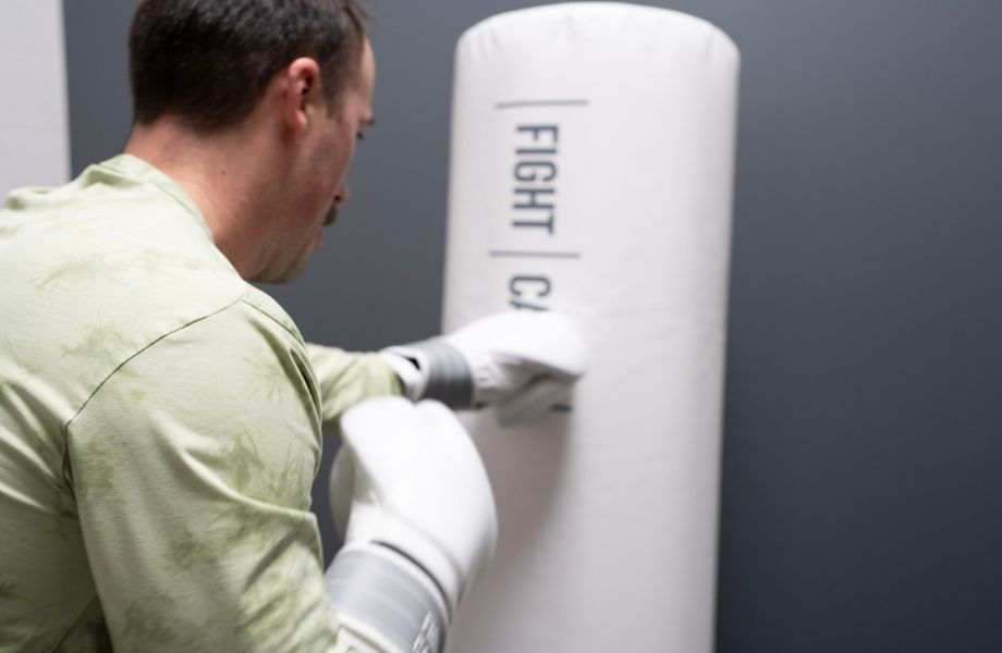 Coop lays into a FightCamp punching bag.