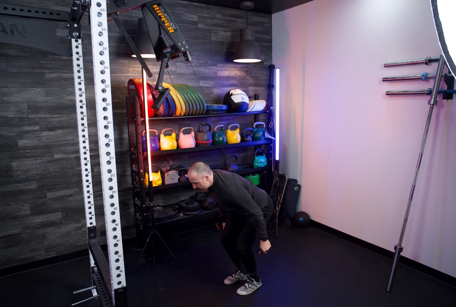 Man in bottom range of motion while using Torque Relentless Ripper ski machine