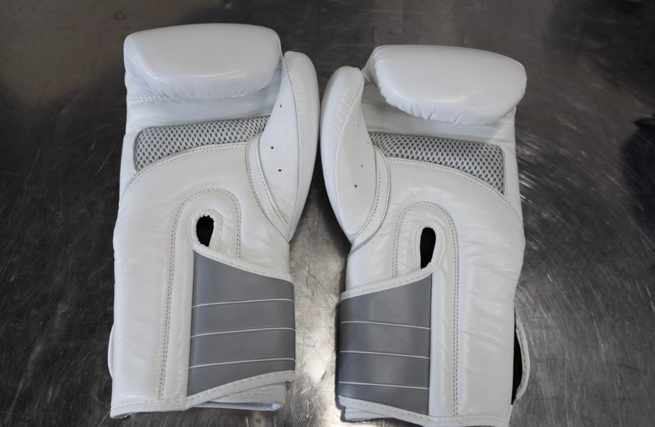 A white pair of FightCamp boxing gloves.