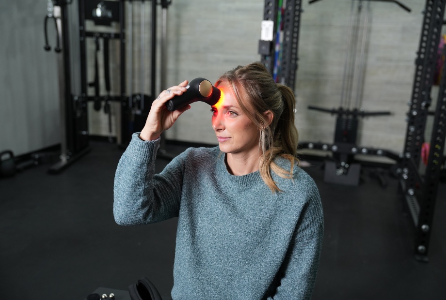 Woman using the Therabody Theraface Pro on her forehead