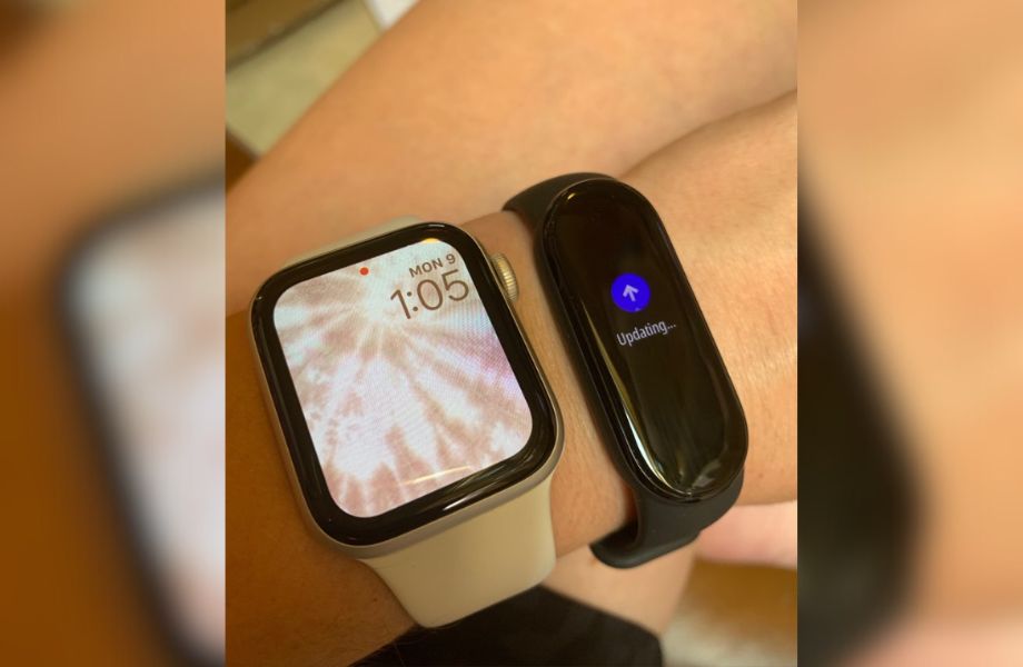 Person wearing both Xiaomi Mi Smart Band 6 and Apple Watch