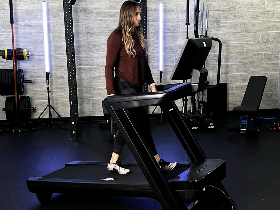 A woman walking on the NordicTrack Commercial 1750 at an incline