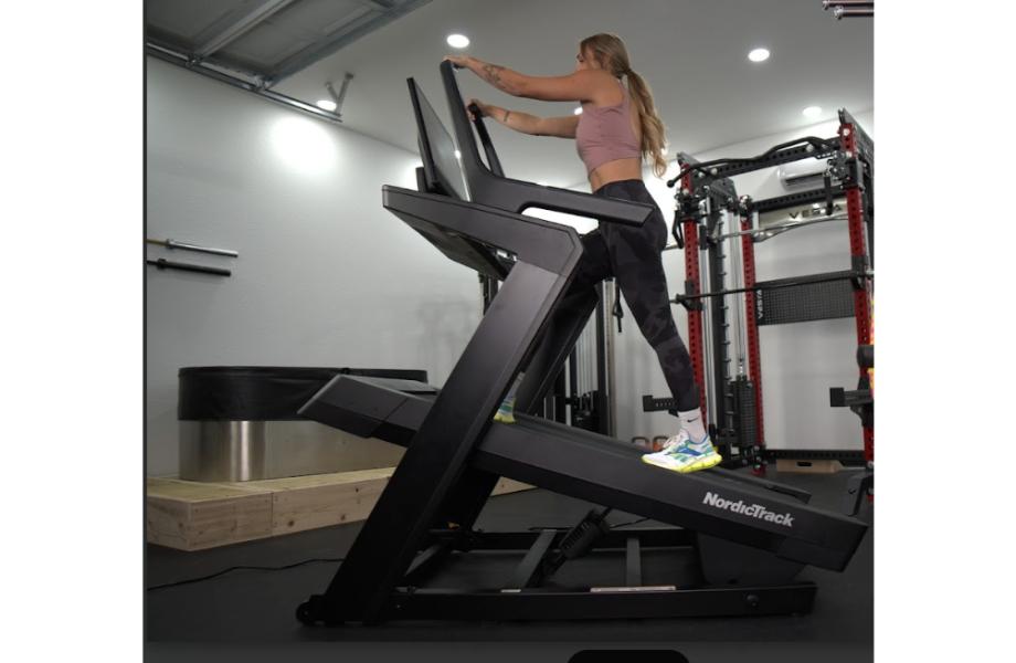 A person using the NordicTrack X24 Incline Treadmill at a high incline