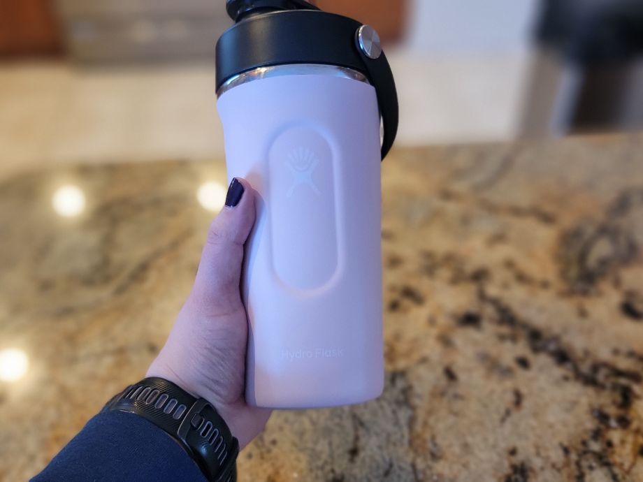 A person holding the Hydro Flask Shaker Bottle after mixing up a protein shake