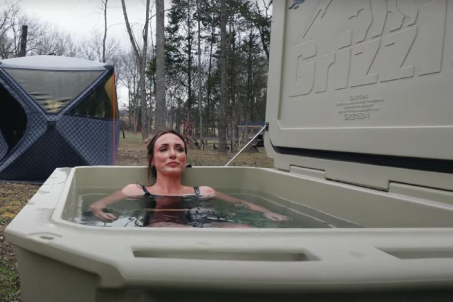 A woman sitting in the Desert Plunge Wide 450 cold plunge tub
