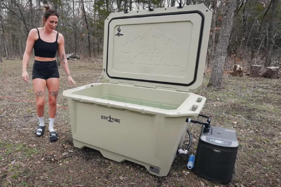 A woman about to step into and use the Desert Cold Plunge Tub