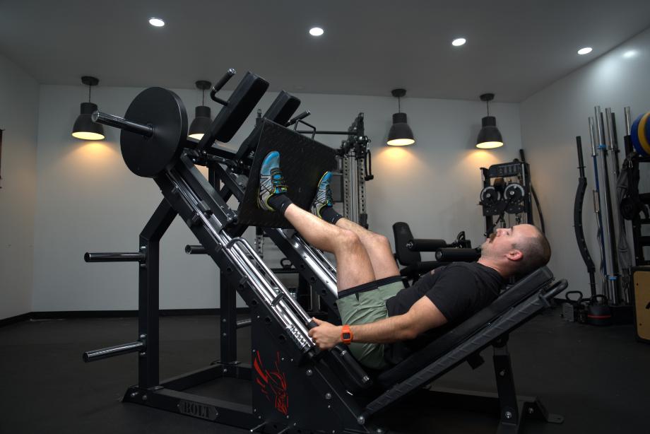 Coop in the middle of a leg press with the Bolt Fitness Hack Squat Leg Press machine.