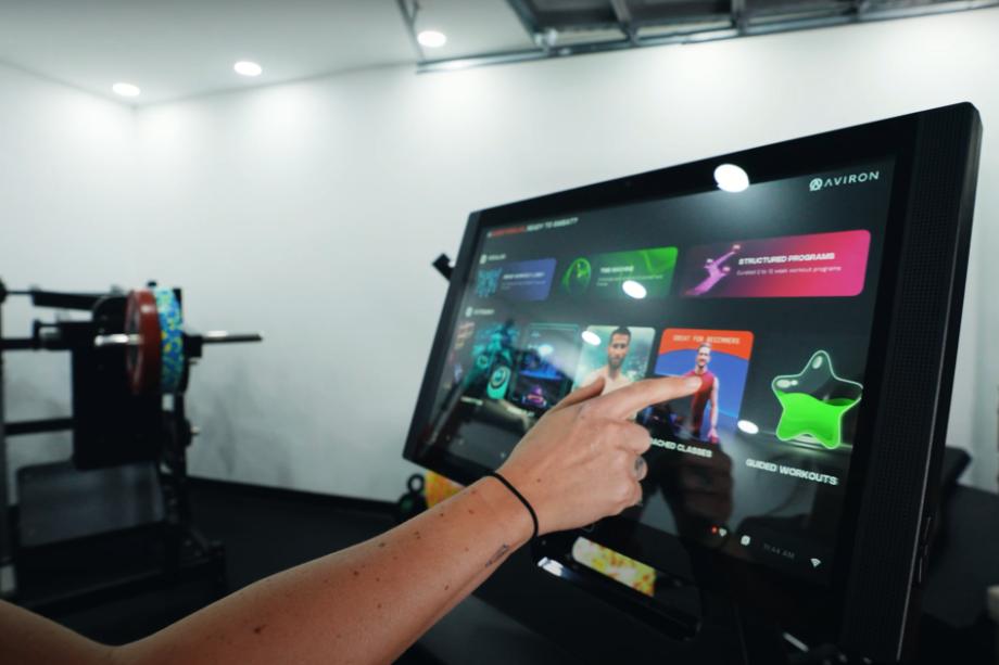 Scrolling the apps on the Aviron Victory Treadmill touchscreen display.