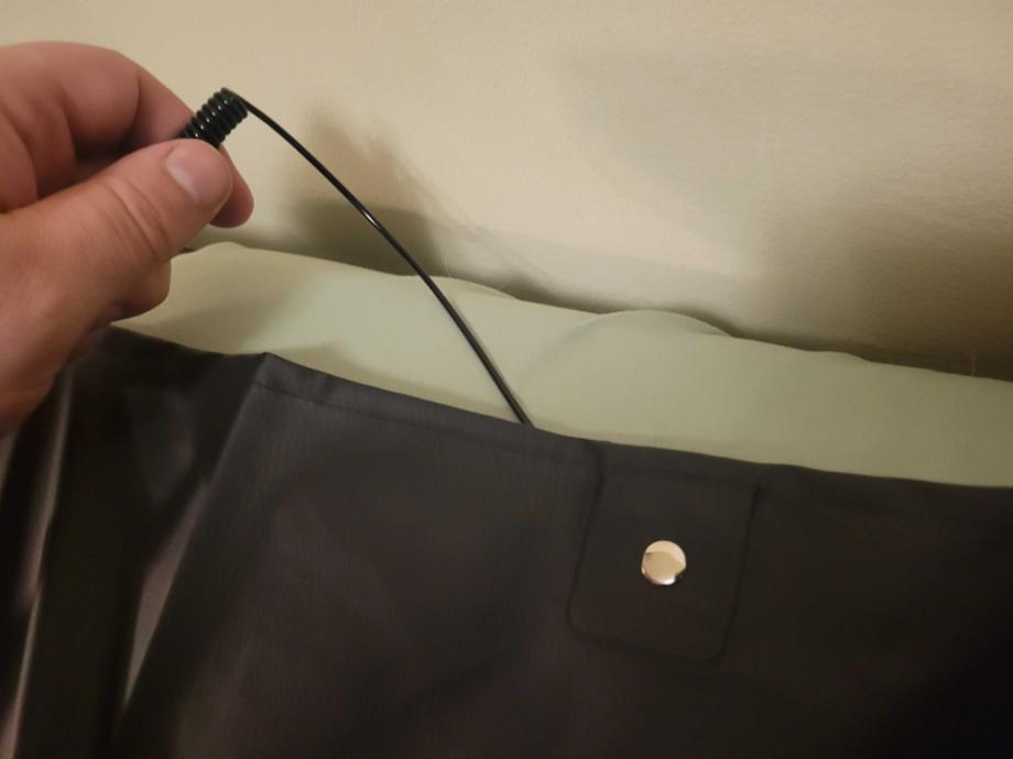 A closeup of the grounding cord and its connection to the Earthing Elite Sleep Mat