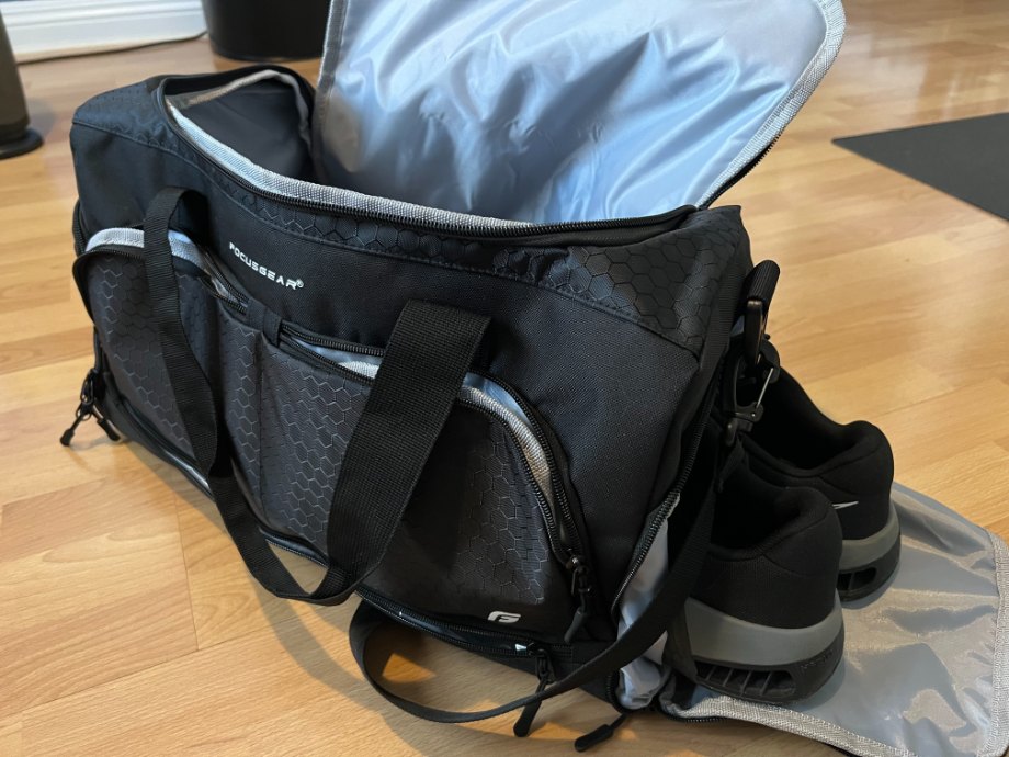 An opened FocusGear Gym Bag with Shoes hanging halfway out of a side pocket