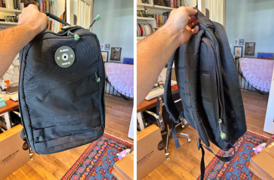 A person holds up a GoRuck GR1 backpack