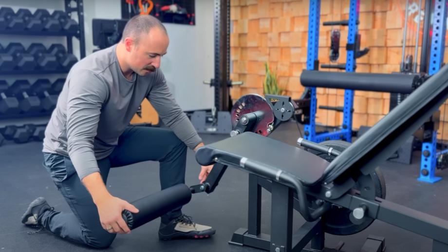 Coop demonstrates the swivel on the RitFit PLC01 Leg Extension Curl Machine