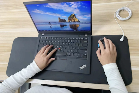 Terra Grounding Mat positioned under a laptop as a woman works