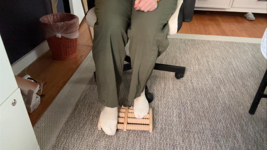 A person uses a Theraflow Foot Roller