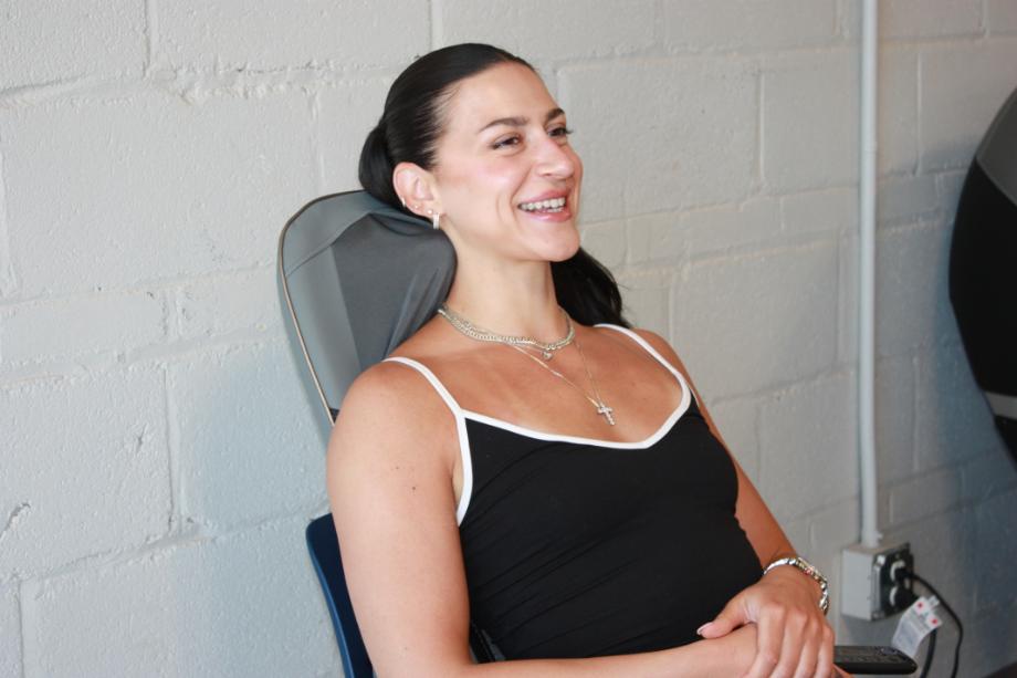 A woman smiles while getting a Homedics Shiatsu Elite II neck massage.