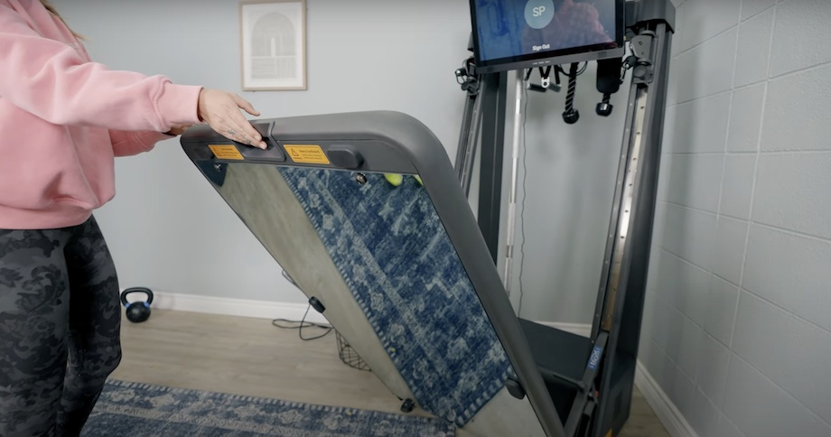 A person lifts the mirrored base of an Echelon Strength Home.