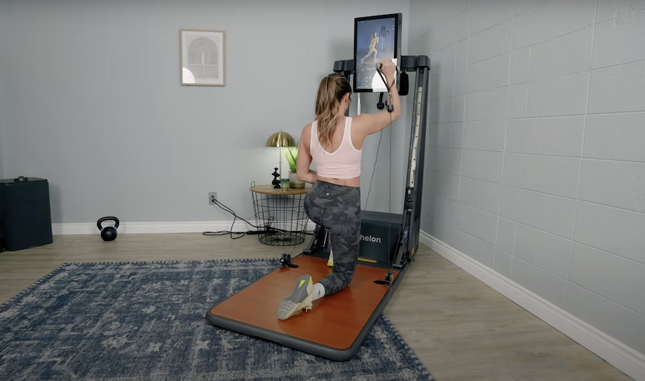 Lindsay Scheele kneels during a workout on the Echelon Strength Home.