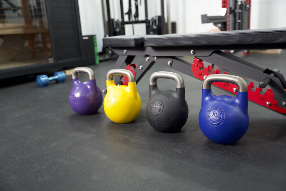Multiple Bells of Steel Adjustable Kettlebells lined up in a row