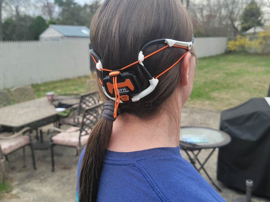 Side View of a woman wearing a PETZL Iko Core headlamp