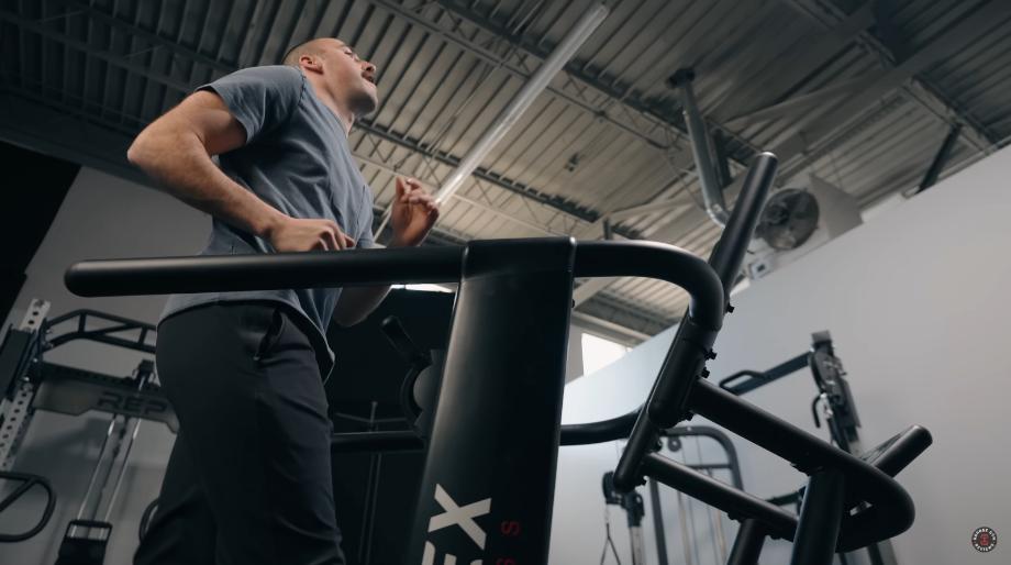 A man running on the Xebex Runner Manual Treadmill