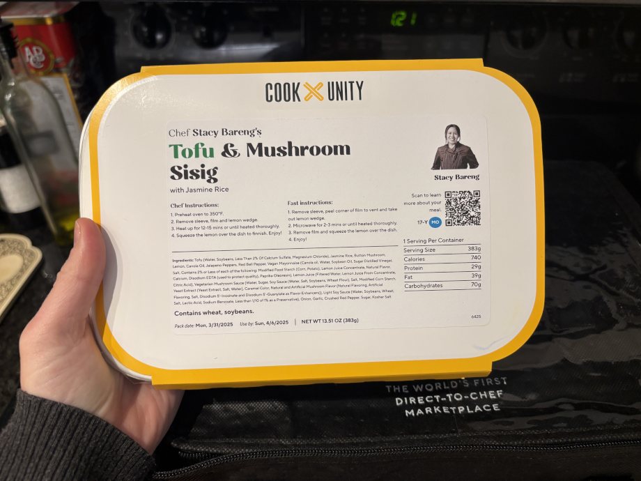 Looking down at a CookUnity meal in hand.