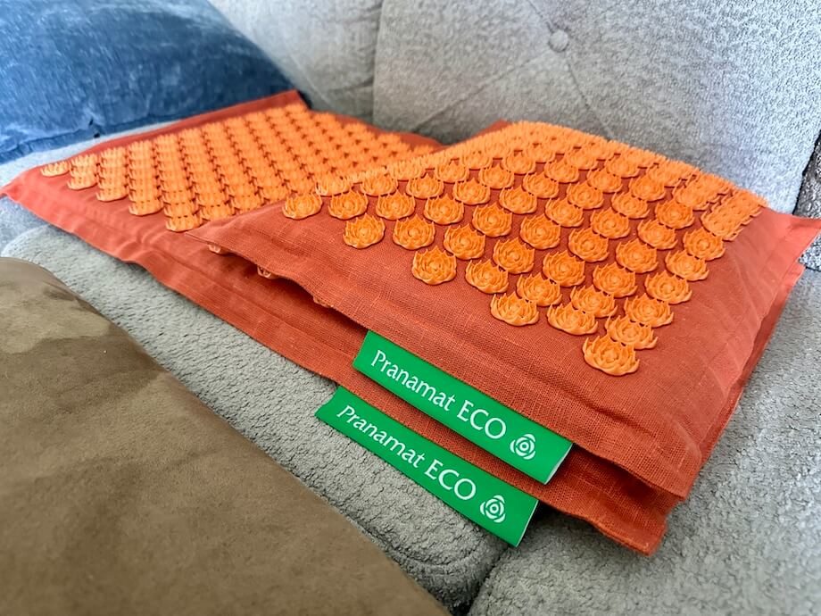 A Pranamat Accupressure Mat sitting on couch prior to session.