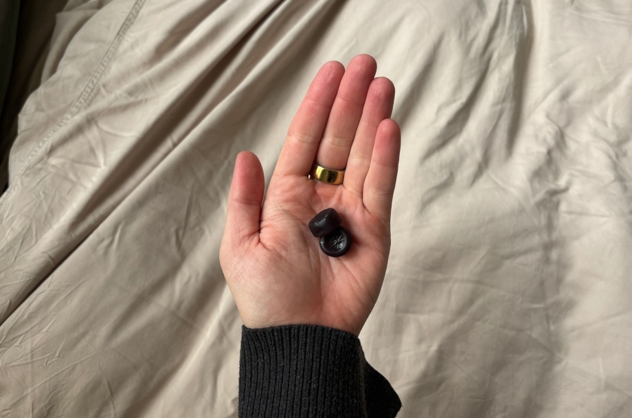 A person holds some Olly Sleep Gummies in their hand.