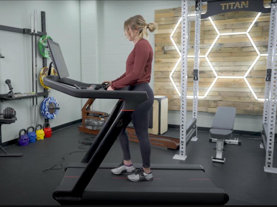 A woman walking on the Peloton Tread