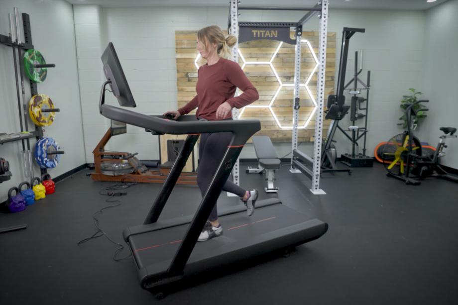 A woman running on the Peloton Tread testing for our Peloton Tread review