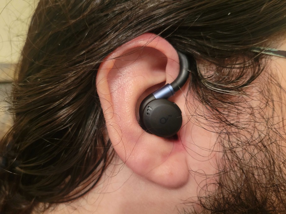 Olympian Caine Wilkes wearing an Anker Soundcore Sport X20 wireless earbud.