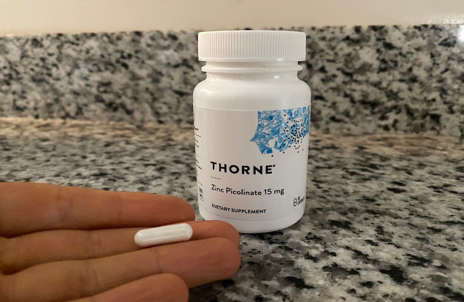 Our tester holding a capsule of Thorne Zinc Picolinate