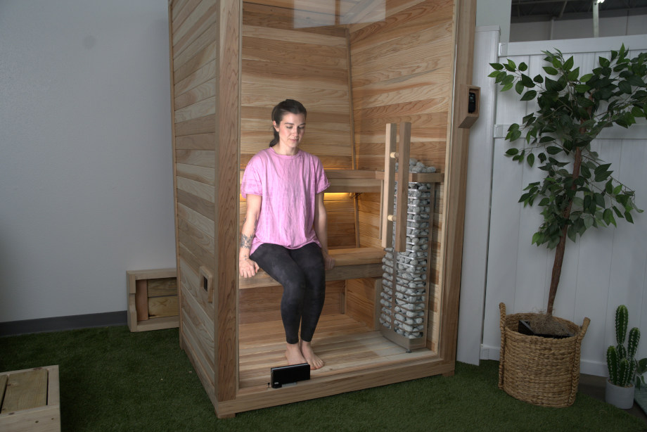 Our tester Jess sits on the bottom bench in a Plunge Sauna Mini