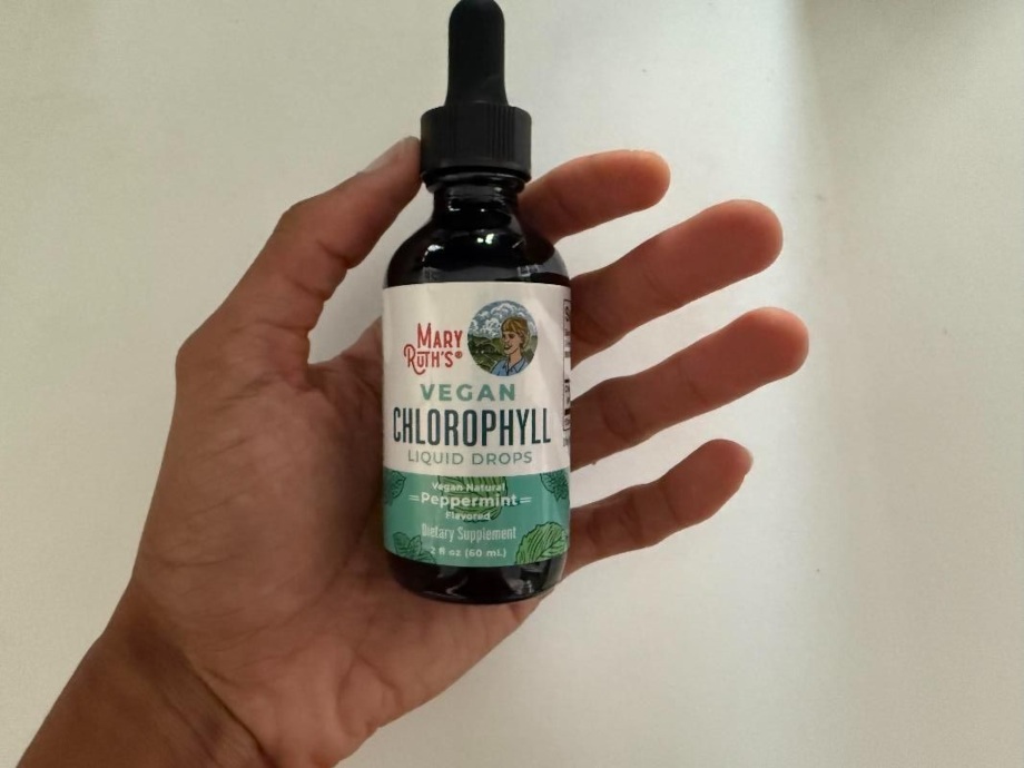 Our tester holds up a bottle of Mary Ruth's Vegan Liquid Chlorophyll