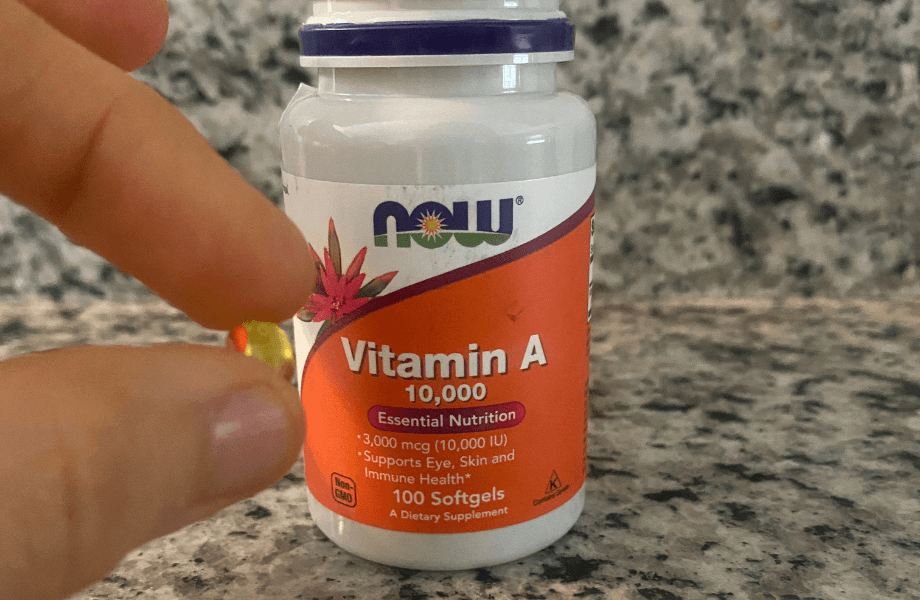 Our tester holding a single NOW Foods Vitamin A 10,000 IU Softgel