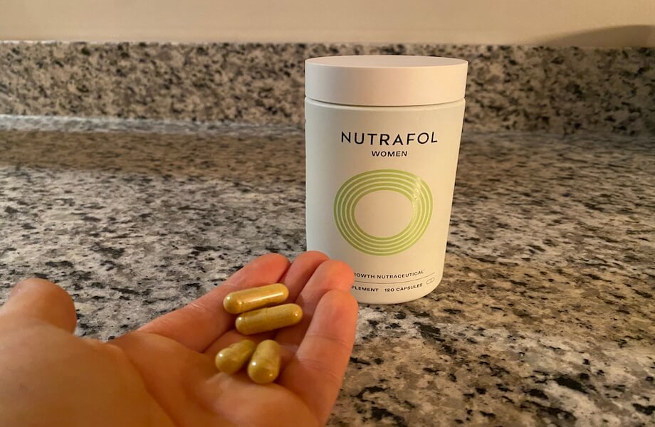 Our tester holding a handful of Nutrafol Women’s Hair Growth Nutraceutical capsules