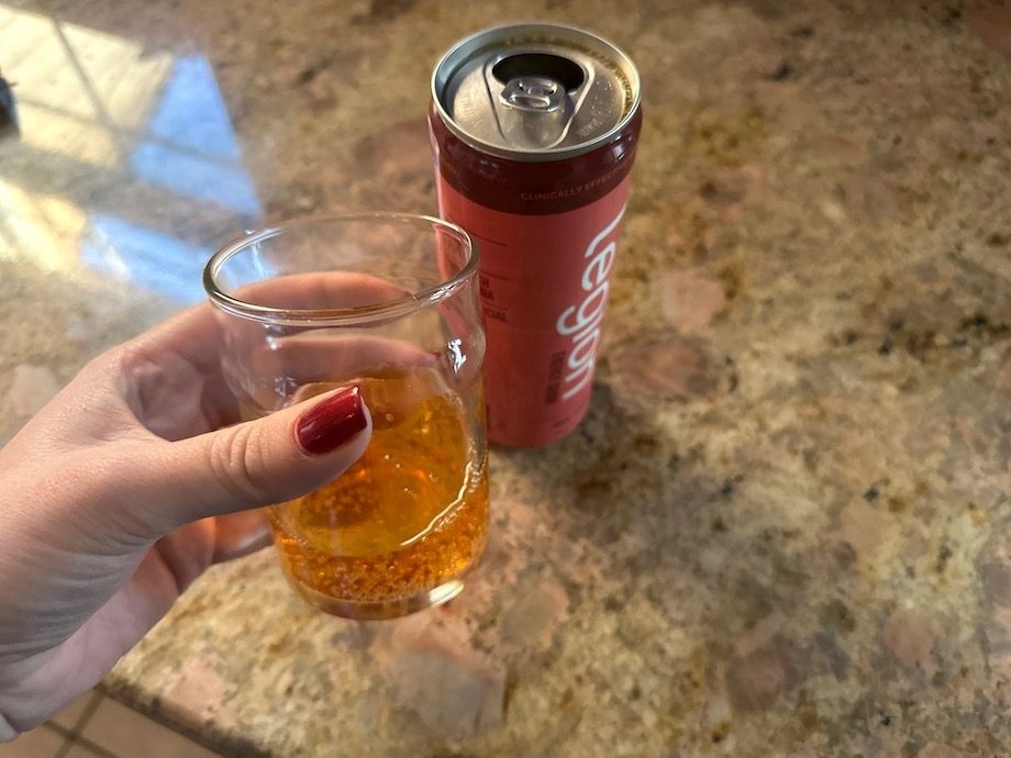 Our tester holds a glass of the Legion Energy Drink