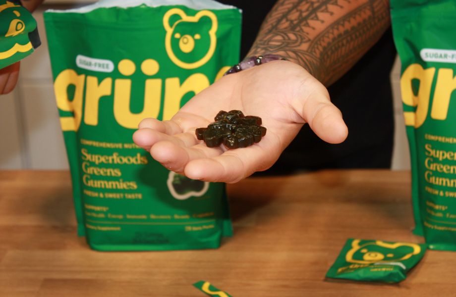 Person holding Grüns gummies in his hand