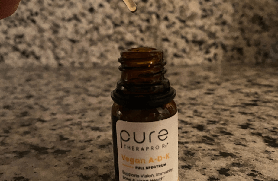 An open container of Pure TheraPro Rx Vegan A-D-K Drops