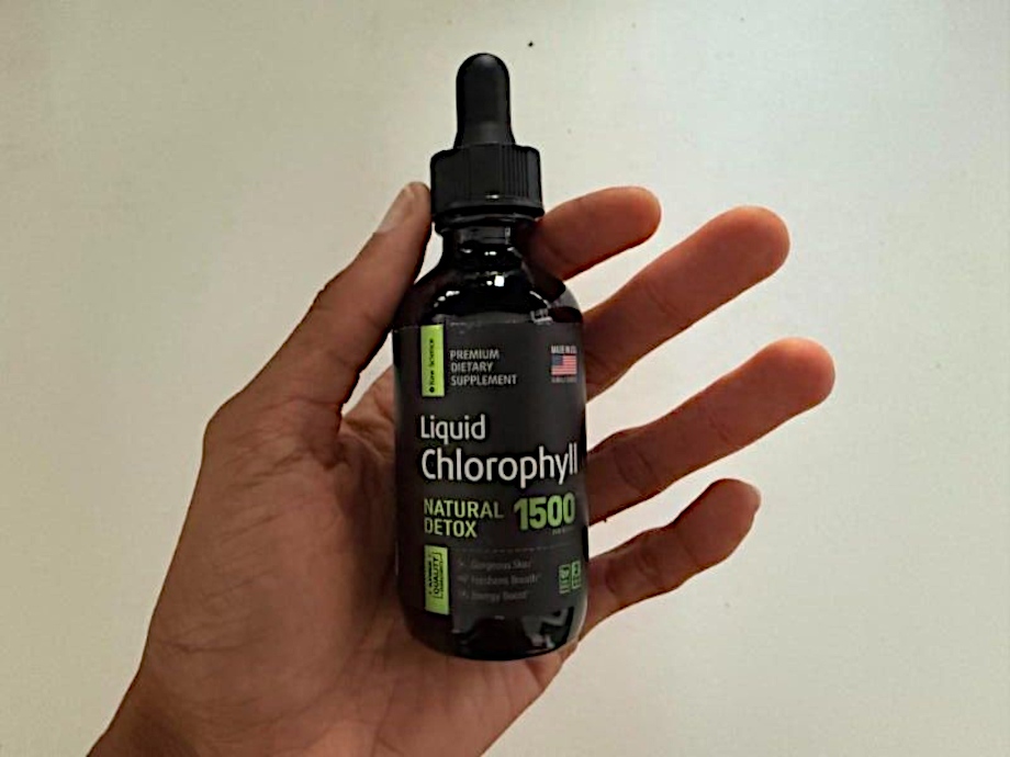 Our tester holds up a bottle of Raw Science Liquid Chlorophyll