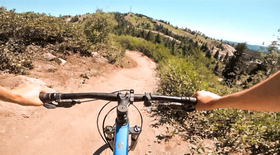 POV perspective riding down a dirt trail on a Trek Marlin 2
