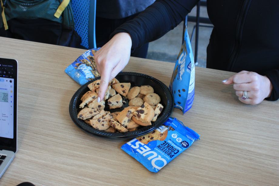 Our tester points to a tray of Quest Nutrition Chocolate Chip Protein Cookies