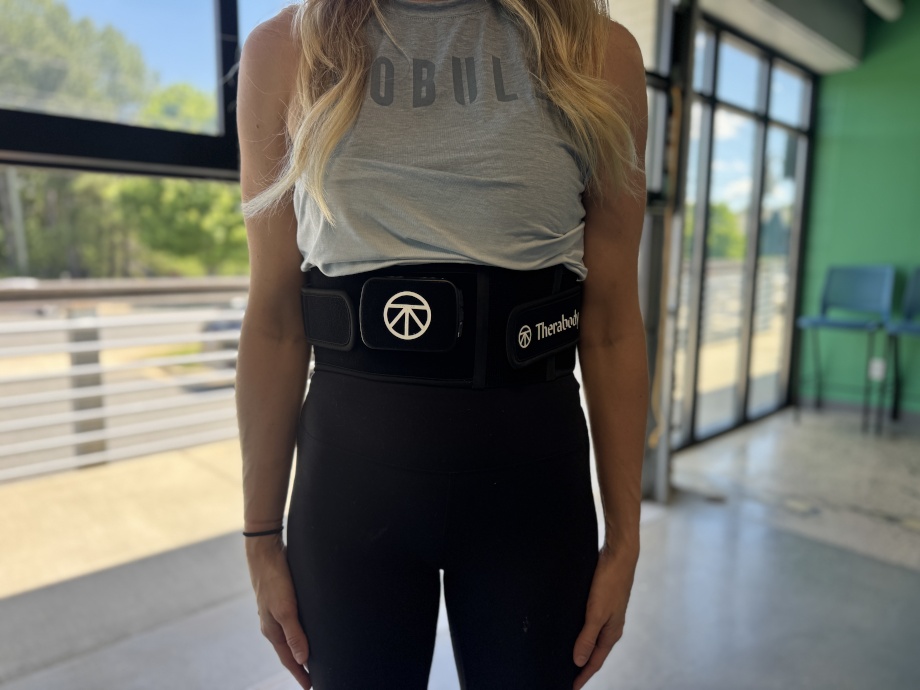 Front view of a person wearing a Therabody Thermback LED