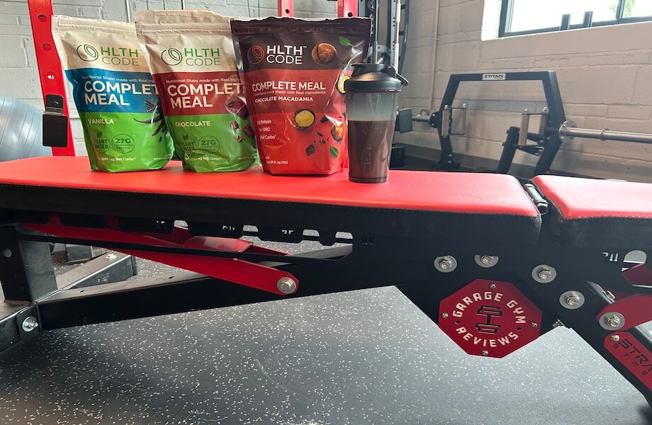 A shaker next to multiple bags of HLTH Code Complete Meal