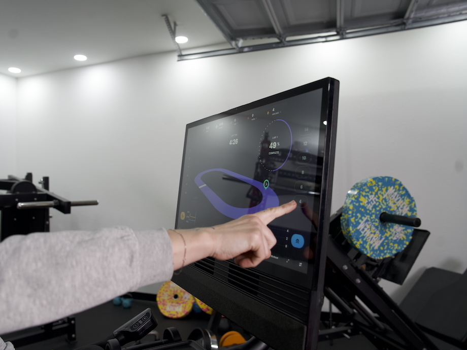 Product tester using the touchscreen on the NordicTrack X24 bike